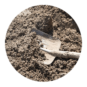 a shovel covered in and sitting in mud